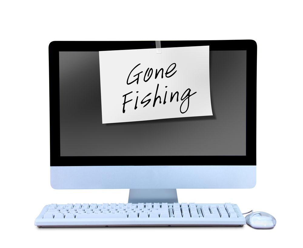 Gone fishing sign on desktop computer