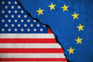United States and European Union flags on walls crumbled into each other