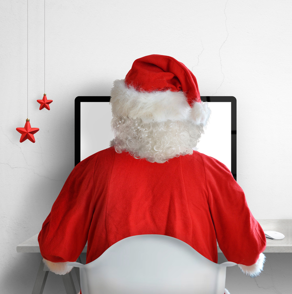 Santa sat at desktop working